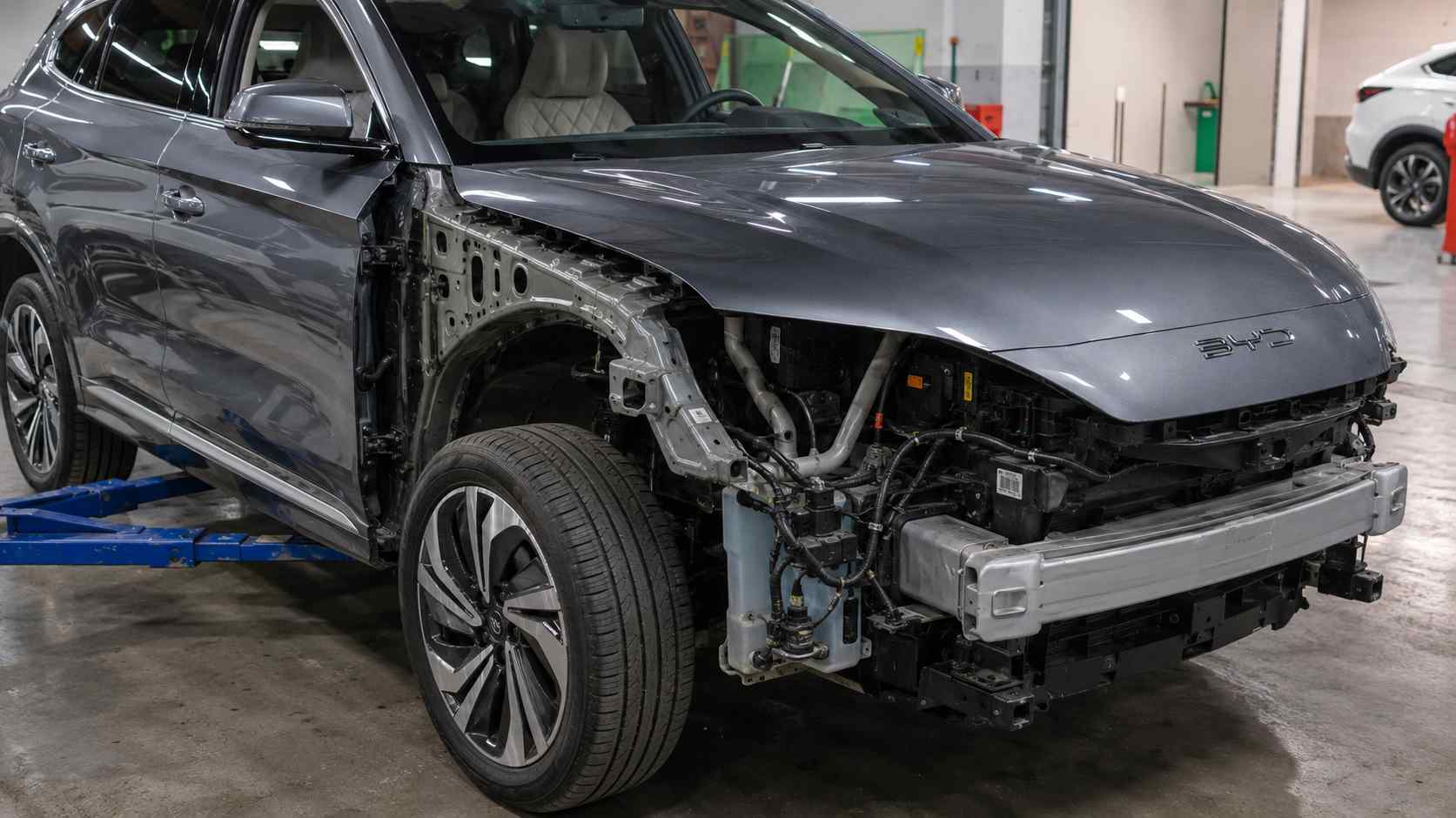 Technician identifying BYD construction and equipment differences across the vehicle range