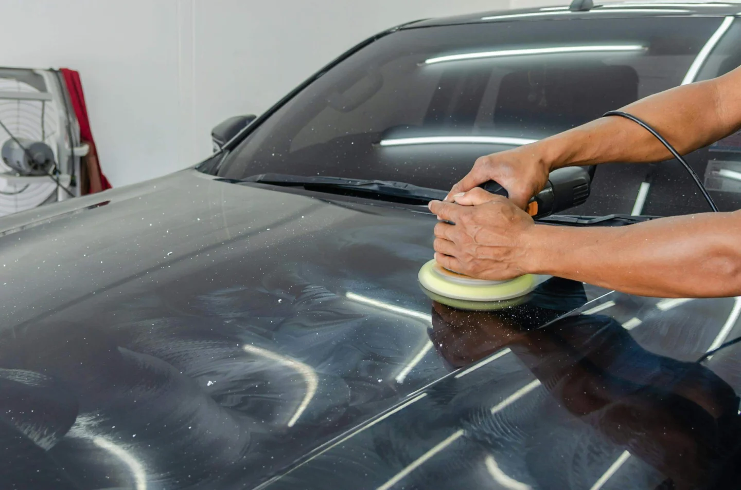 Machine polishing a glossy car panel