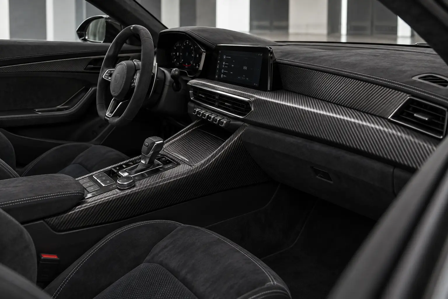 Black performance interior with fitted woven carbon-fibre console trim