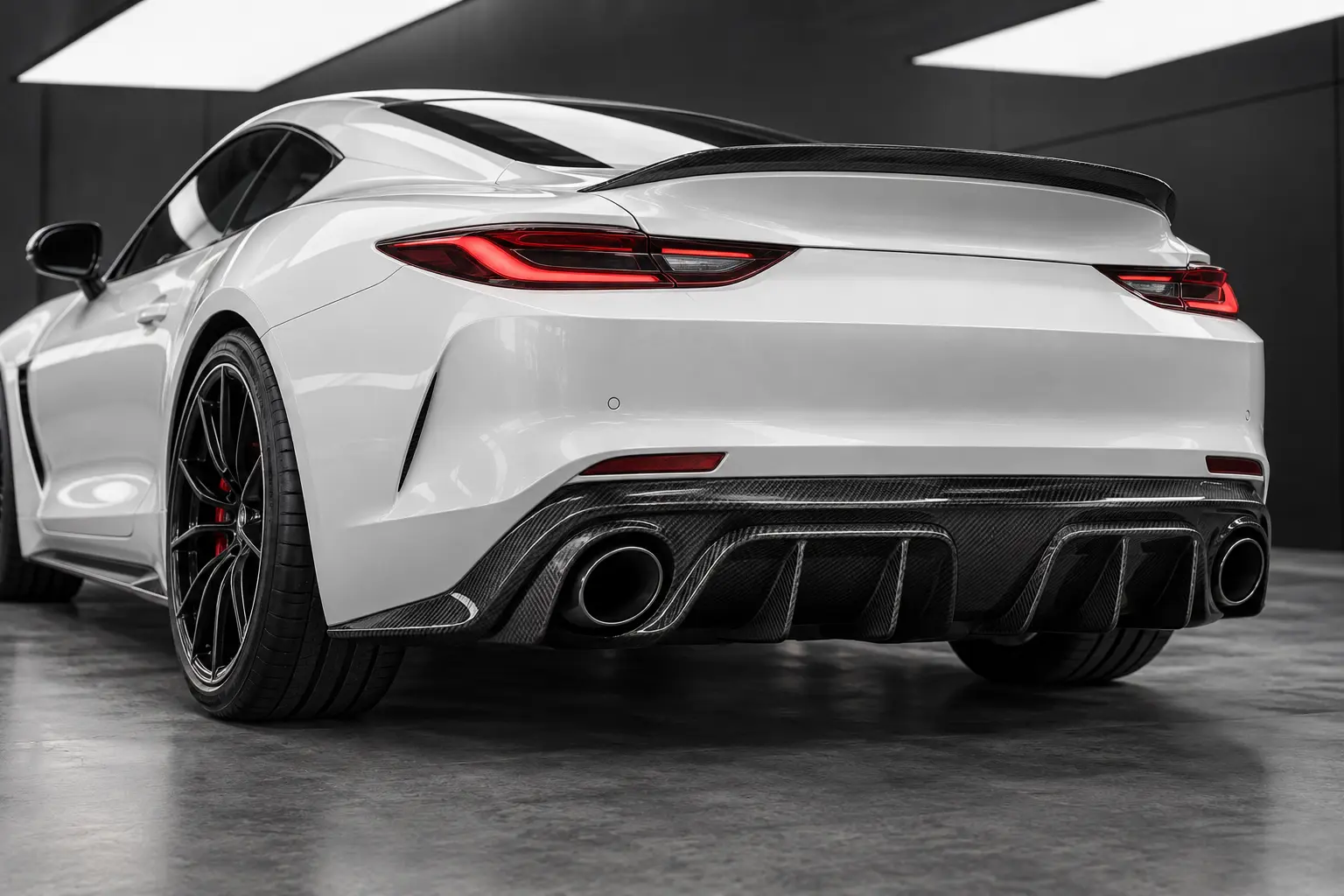 Finished woven carbon-fibre rear diffuser aligned beneath a performance car